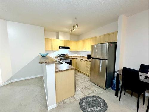 1310-333 Taravista Drive Ne, Calgary, AB - Indoor Photo Showing Kitchen With Stainless Steel Kitchen With Double Sink