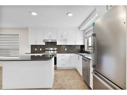 26 Luxstone Point Sw, Airdrie, AB - Indoor Photo Showing Kitchen With Stainless Steel Kitchen With Upgraded Kitchen