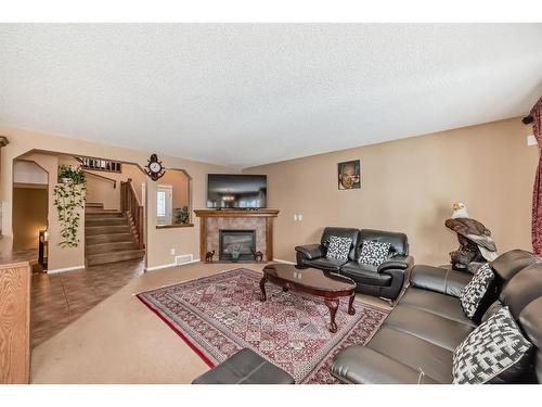 47 Panamount Heights Nw, Calgary, AB - Indoor Photo Showing Living Room With Fireplace