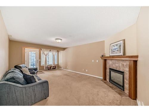 47 Panamount Heights Nw, Calgary, AB - Indoor Photo Showing Living Room With Fireplace