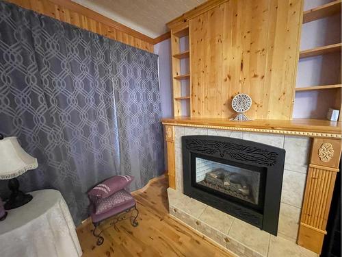 2130 19 Avenue, Didsbury, AB - Indoor Photo Showing Living Room With Fireplace