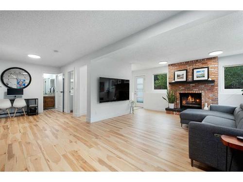 11 Oakmount Way Sw, Calgary, AB - Indoor Photo Showing Living Room With Fireplace