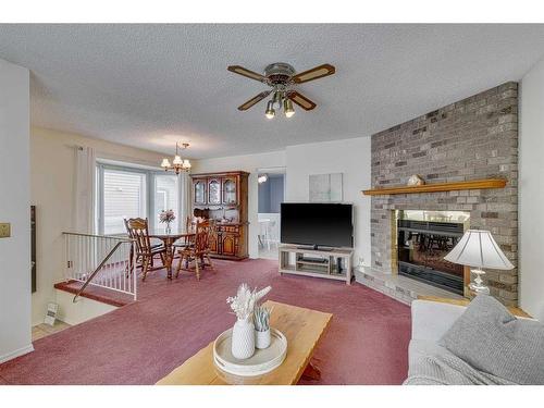 20 Riverbrook Place Se, Calgary, AB - Indoor Photo Showing Living Room With Fireplace