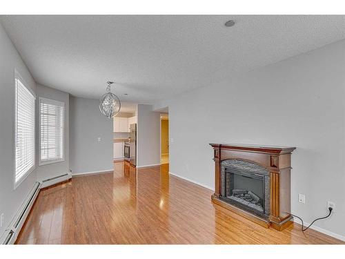 3216-3216 Sienna Park Green Sw, Calgary, AB - Indoor Photo Showing Living Room With Fireplace