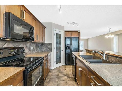 14 Silverado Saddle Heights Sw, Calgary, AB - Indoor Photo Showing Kitchen With Double Sink