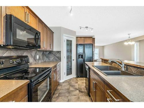 14 Silverado Saddle Heights Sw, Calgary, AB - Indoor Photo Showing Kitchen With Double Sink