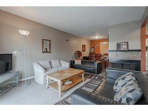 7002 54 Avenue Nw, Calgary, AB - Indoor Photo Showing Living Room With Fireplace