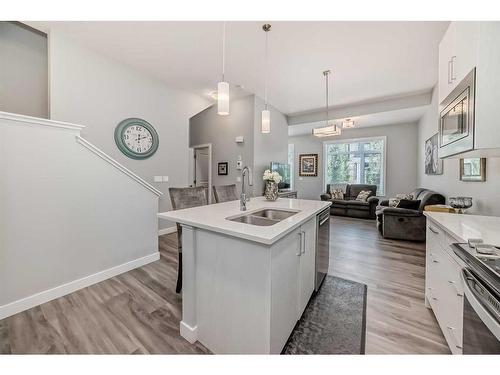 204 Crestbrook Common Sw, Calgary, AB - Indoor Photo Showing Kitchen With Double Sink