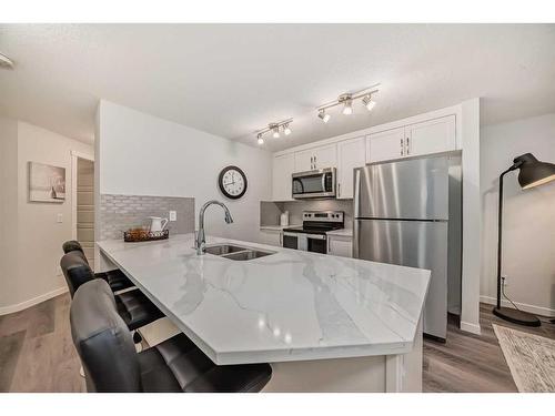 509-474 Seton Circle Se, Calgary, AB - Indoor Photo Showing Kitchen With Stainless Steel Kitchen With Double Sink With Upgraded Kitchen