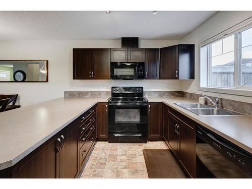 91 Sunset Road, Cochrane, AB - Indoor Photo Showing Kitchen With Double Sink