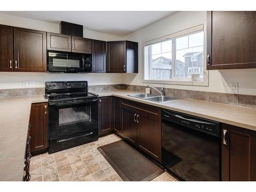 91 Sunset Road, Cochrane, AB - Indoor Photo Showing Kitchen With Double Sink