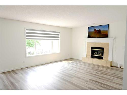 15 Coral Reef Close Ne, Calgary, AB - Indoor Photo Showing Living Room With Fireplace