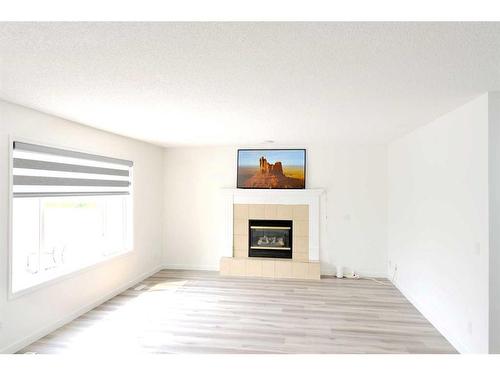 15 Coral Reef Close Ne, Calgary, AB - Indoor Photo Showing Living Room With Fireplace