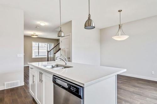 20 Emberside Grove, Cochrane, AB - Indoor Photo Showing Kitchen With Double Sink With Upgraded Kitchen