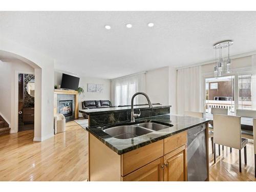 39 Everwillow Close Sw, Calgary, AB - Indoor Photo Showing Kitchen With Fireplace With Double Sink