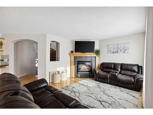 39 Everwillow Close Sw, Calgary, AB - Indoor Photo Showing Living Room With Fireplace