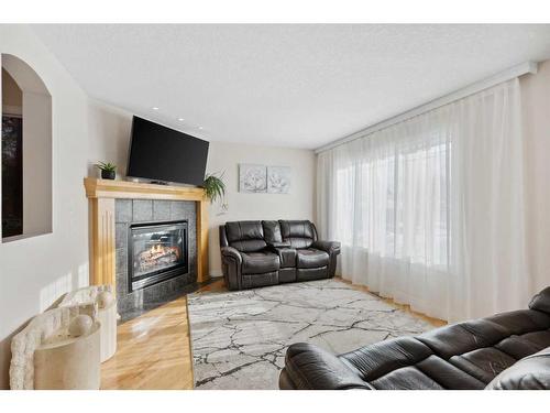 39 Everwillow Close Sw, Calgary, AB - Indoor Photo Showing Living Room With Fireplace