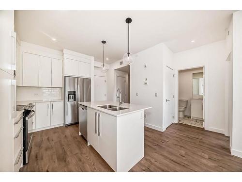 2311-111 Wolf Creek Drive Se, Calgary, AB - Indoor Photo Showing Kitchen With Stainless Steel Kitchen With Double Sink With Upgraded Kitchen