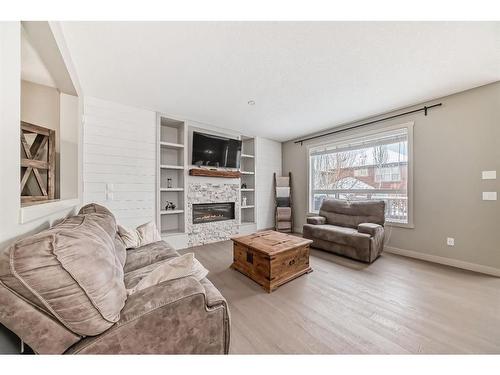 136 Riviera Way, Cochrane, AB - Indoor Photo Showing Living Room With Fireplace