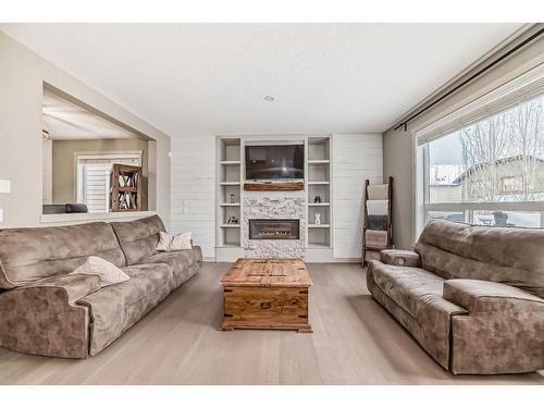 136 Riviera Way, Cochrane, AB - Indoor Photo Showing Living Room With Fireplace