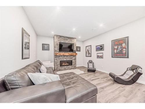 136 Riviera Way, Cochrane, AB - Indoor Photo Showing Living Room With Fireplace