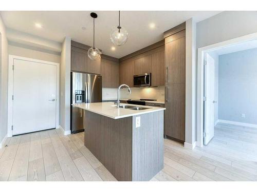 1208-111 Wolf Creek Drive, Calgary, AB - Indoor Photo Showing Kitchen With Stainless Steel Kitchen With Double Sink With Upgraded Kitchen