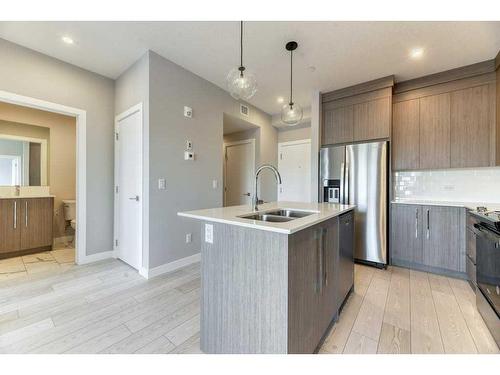 1208-111 Wolf Creek Drive, Calgary, AB - Indoor Photo Showing Kitchen With Stainless Steel Kitchen With Double Sink With Upgraded Kitchen