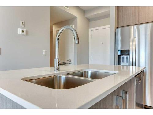 1208-111 Wolf Creek Drive, Calgary, AB - Indoor Photo Showing Kitchen With Double Sink