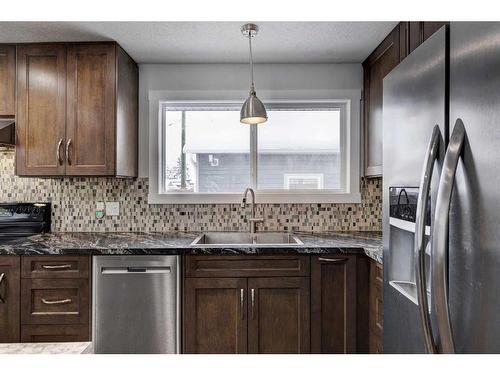 224 Queen Charlotte Way Se, Calgary, AB - Indoor Photo Showing Kitchen With Double Sink