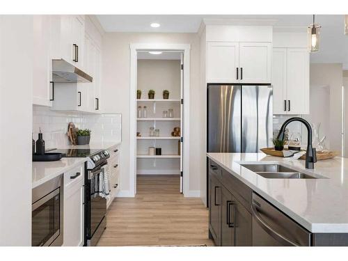 487 Kinniburgh Loop, Chestermere, AB - Indoor Photo Showing Kitchen With Stainless Steel Kitchen With Double Sink With Upgraded Kitchen