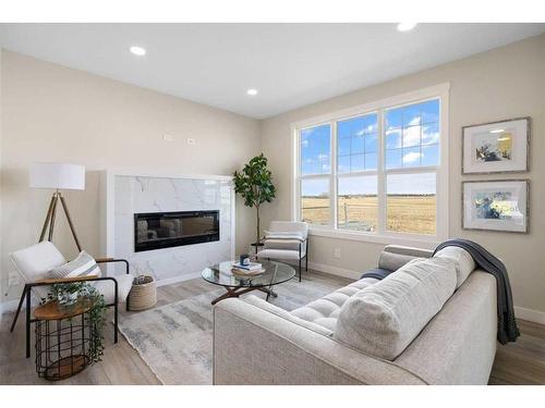 487 Kinniburgh Loop, Chestermere, AB - Indoor Photo Showing Living Room With Fireplace