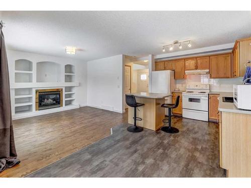 23 Saddleback Way Ne, Calgary, AB - Indoor Photo Showing Kitchen With Fireplace