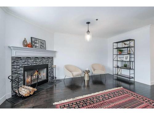 304-916 19 Avenue Sw, Calgary, AB - Indoor Photo Showing Living Room With Fireplace