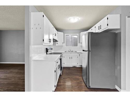 8 Taraglen Road Ne, Calgary, AB - Indoor Photo Showing Kitchen With Double Sink