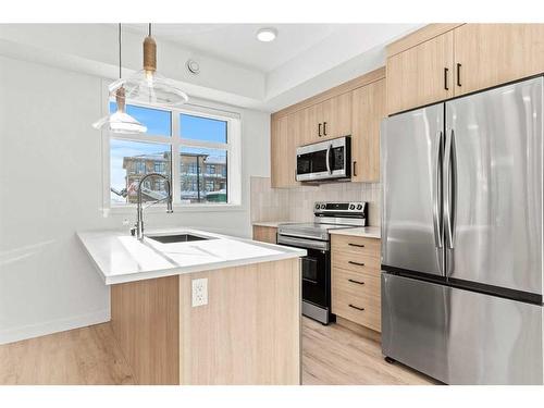 312-562 Seton Circle Se, Calgary, AB - Indoor Photo Showing Kitchen With Stainless Steel Kitchen With Upgraded Kitchen