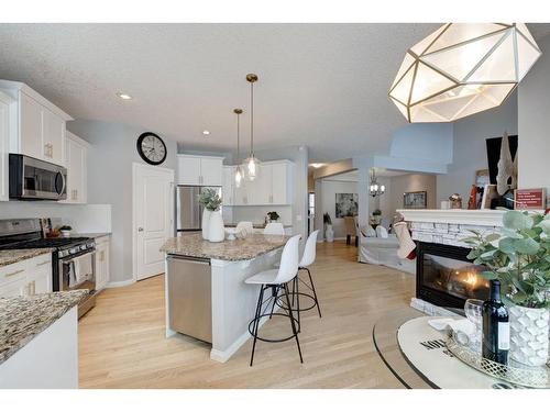 16 Ridge View Close, Cochrane, AB - Indoor Photo Showing Kitchen With Fireplace With Stainless Steel Kitchen With Upgraded Kitchen