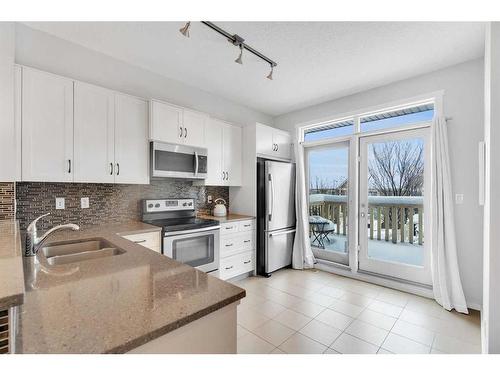 26 Kinlea Common Nw, Calgary, AB - Indoor Photo Showing Kitchen With Stainless Steel Kitchen With Double Sink