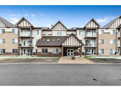 1302-200 Community Way, Okotoks, AB - Outdoor With Balcony With Facade