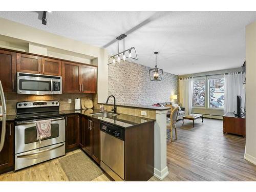 108-205 Sunset Drive, Cochrane, AB - Indoor Photo Showing Kitchen With Stainless Steel Kitchen