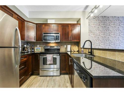 108-205 Sunset Drive, Cochrane, AB - Indoor Photo Showing Kitchen With Stainless Steel Kitchen