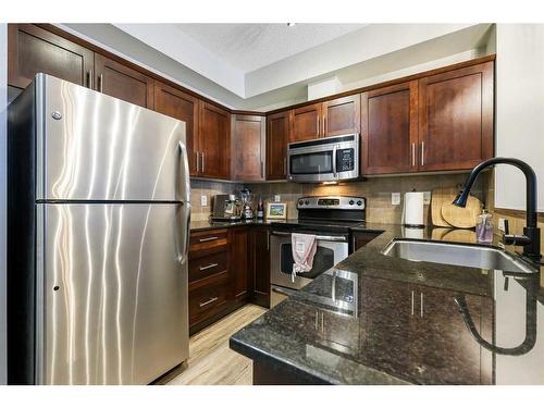 108-205 Sunset Drive, Cochrane, AB - Indoor Photo Showing Kitchen With Stainless Steel Kitchen