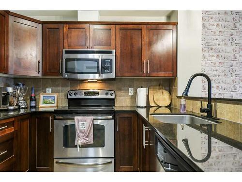 108-205 Sunset Drive, Cochrane, AB - Indoor Photo Showing Kitchen With Stainless Steel Kitchen With Upgraded Kitchen