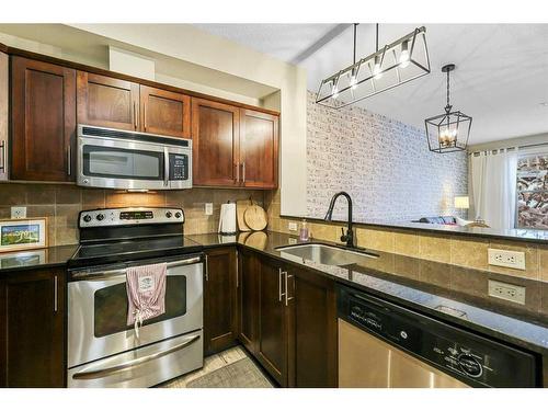 108-205 Sunset Drive, Cochrane, AB - Indoor Photo Showing Kitchen With Stainless Steel Kitchen