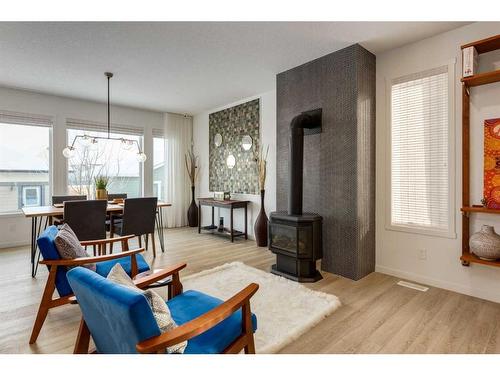 332 South Harmony Drive, Rural Rocky View County, AB - Indoor Photo Showing Living Room With Fireplace