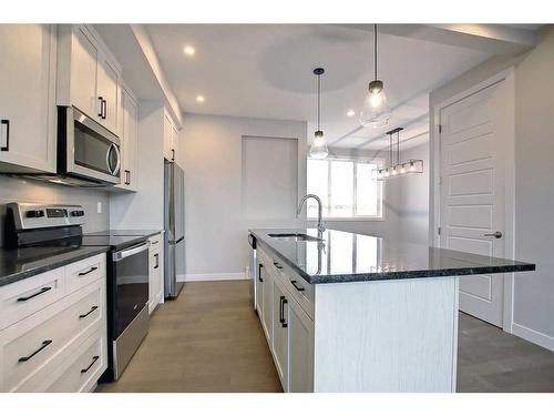 310 Sundown Road, Cochrane, AB - Indoor Photo Showing Kitchen With Upgraded Kitchen