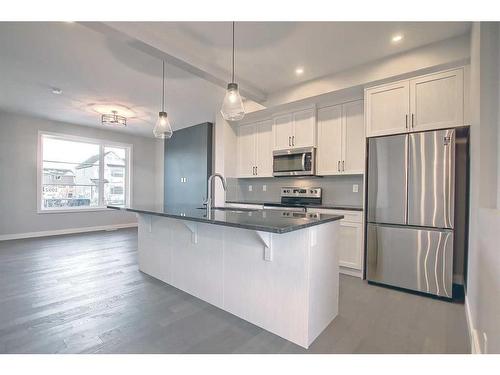 310 Sundown Road, Cochrane, AB - Indoor Photo Showing Kitchen With Stainless Steel Kitchen With Upgraded Kitchen