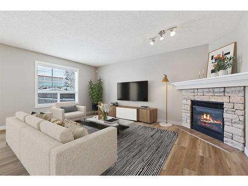 46 Chapman Close Se, Calgary, AB - Indoor Photo Showing Living Room With Fireplace