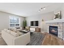 46 Chapman Close Se, Calgary, AB  - Indoor Photo Showing Living Room With Fireplace 