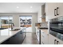 543 Belmont Heath Sw, Calgary, AB  - Indoor Photo Showing Kitchen With Double Sink With Upgraded Kitchen 