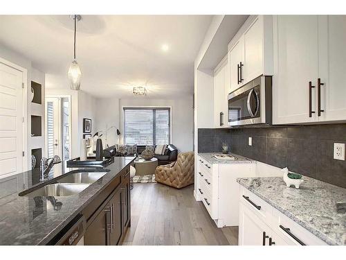 51 Lambeau Lane Se, Airdrie, AB - Indoor Photo Showing Kitchen With Double Sink With Upgraded Kitchen